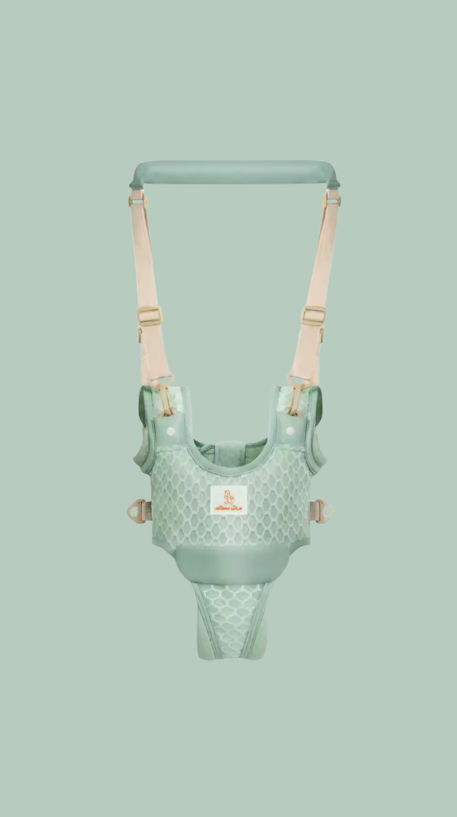 Green baby harness with beige straps on a light green background