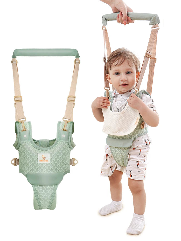 Baby in a green harness with a white background