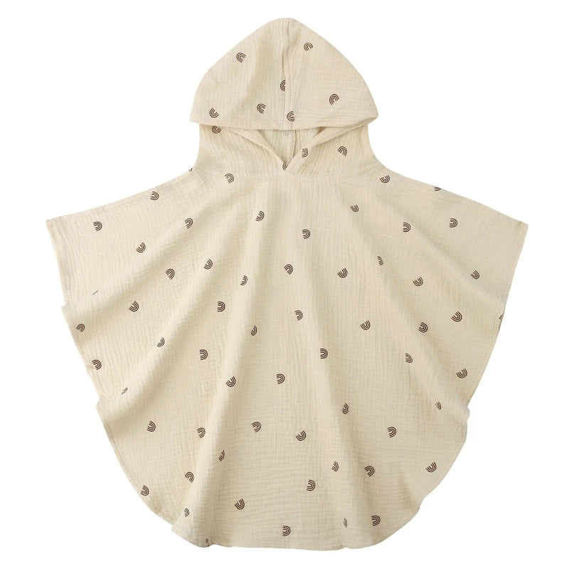 Beige hooded poncho with small patterns on a white background