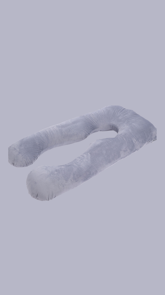 U-shaped pregnacy pillow against a gray sky