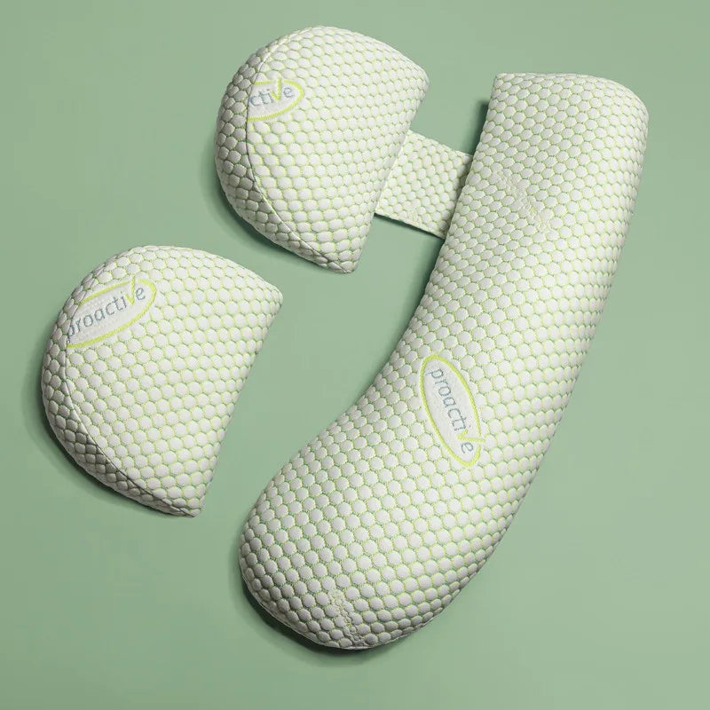 Three textured pillows on a green background